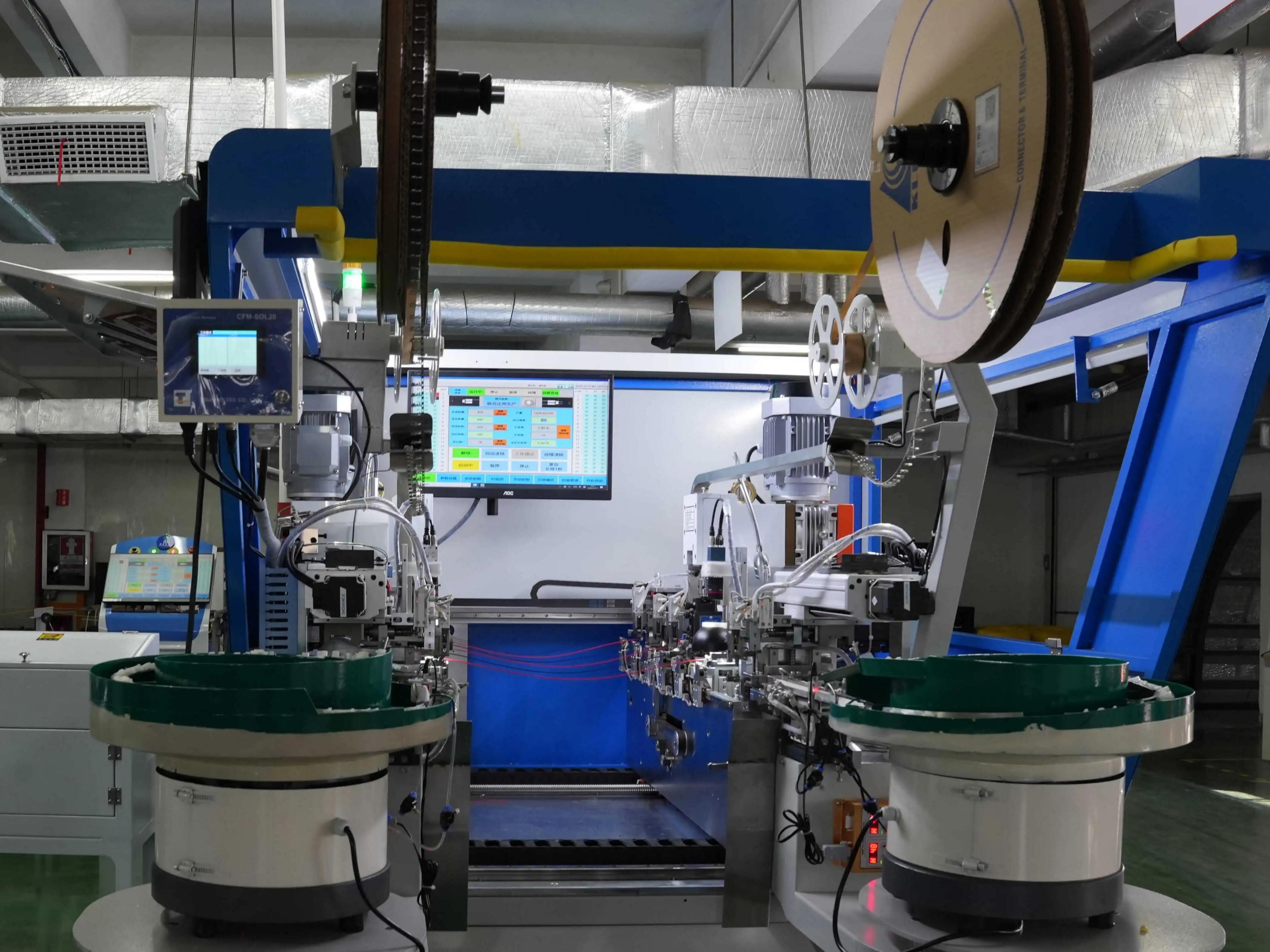 Automated manufacturing machine with control panels in a factory setting