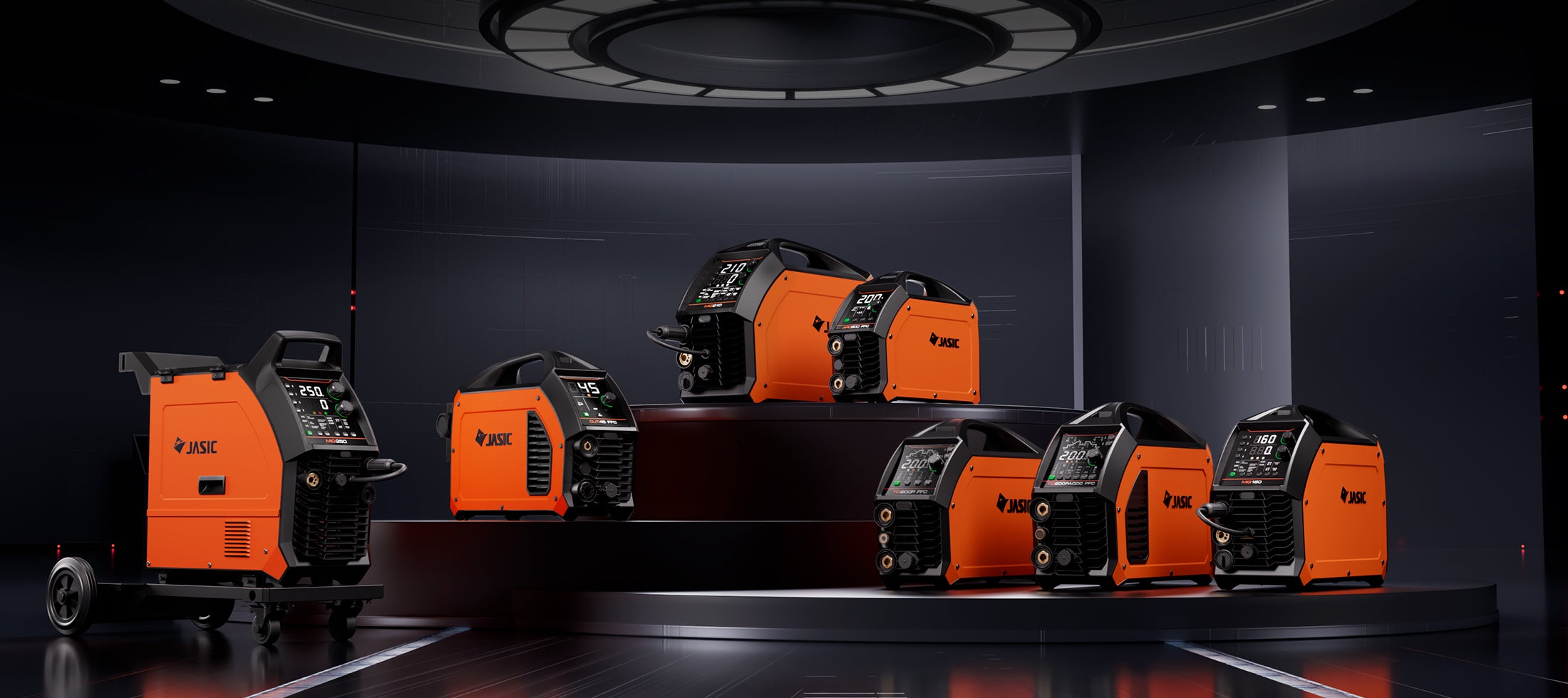 Lineup of orange industrial welding machines and plasma cutters displayed in a modern, dark setting